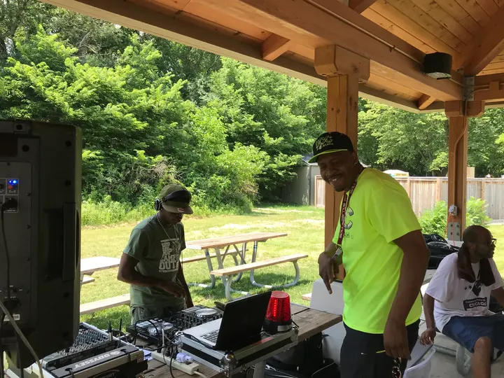 A DJ setup under the picnic shelter.