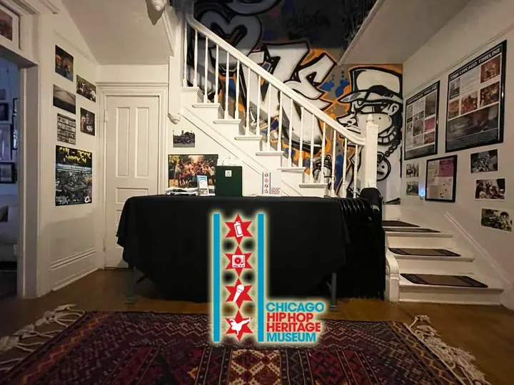 The museum's front room, with a staircase and framed photos.